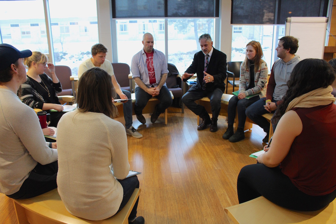 Law students in the Native Law Centre's Circle Room with coach Michael Gatin.