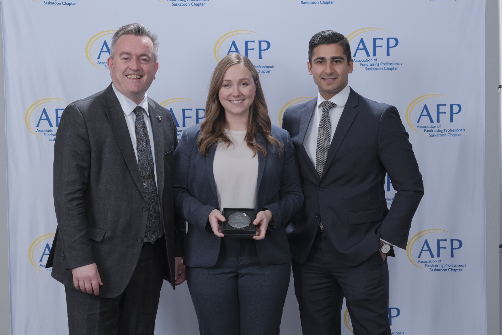 Dean of Law Martin Phillipson with members of 2017-18’s Law Students' Association Executive, Jacey Safnuk and Marek Coutu as they receive the Youth in Philanthropy award from the University of Saskatchewan.
