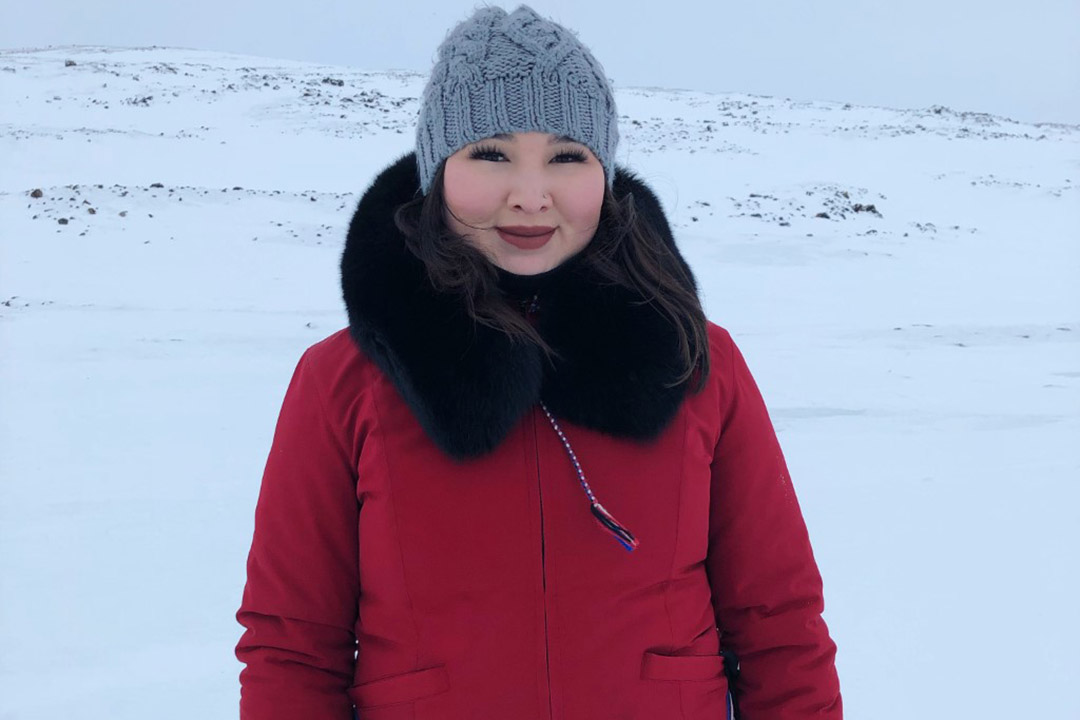 Photo of  Nuka Olsen-Hakongak wearing a red winter parka