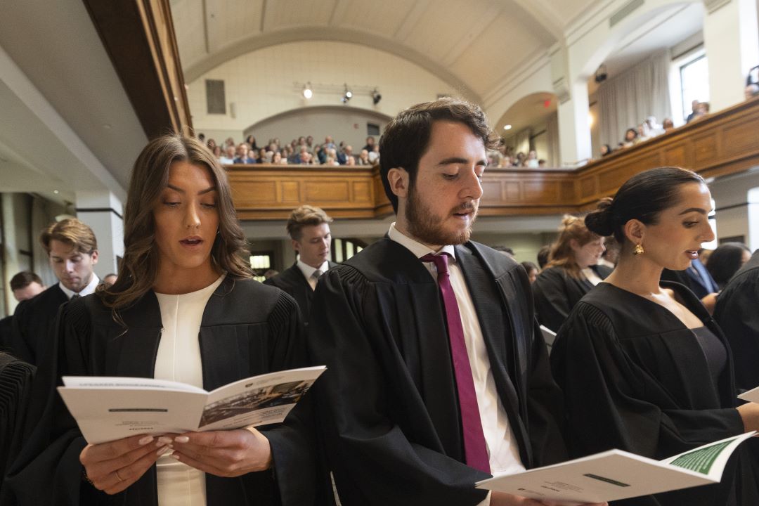 First-year law students hold booklets and recite the Student Commitment at the First-Year Welcoming Ceremony