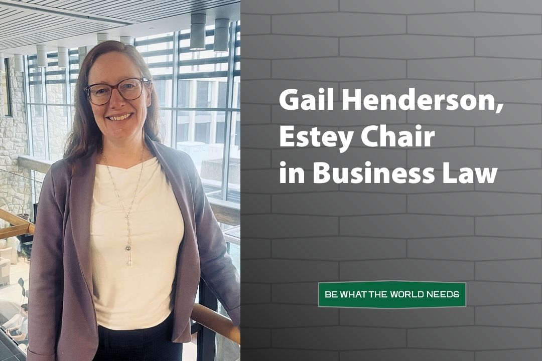Gail Henderson standing in the USask Law building for a portrait photo.