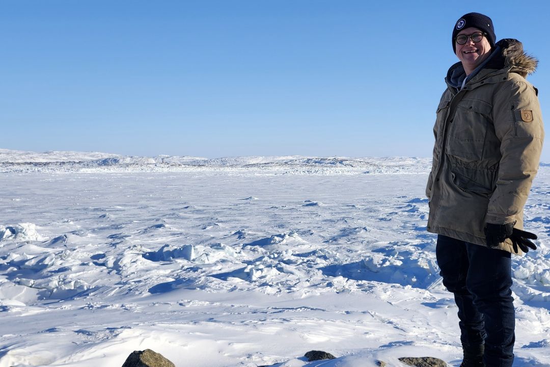 Photo of Benjamin Ralston standing at Iqaluit Harbour
