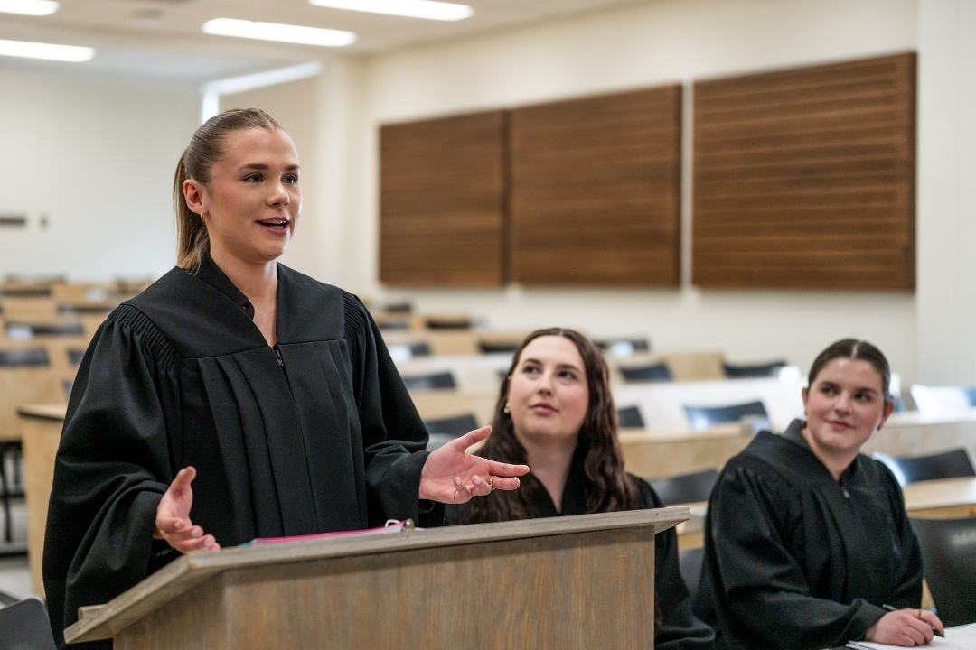 Law students in black robe court attire present their case arguments during the annual first-year moot.