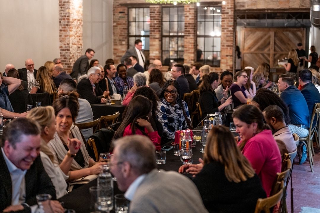 USask Law faculty, staff, and community members gather in a rustic brick venue for the Appreciation Dinner and Farewell for Dean Martin Phillipson